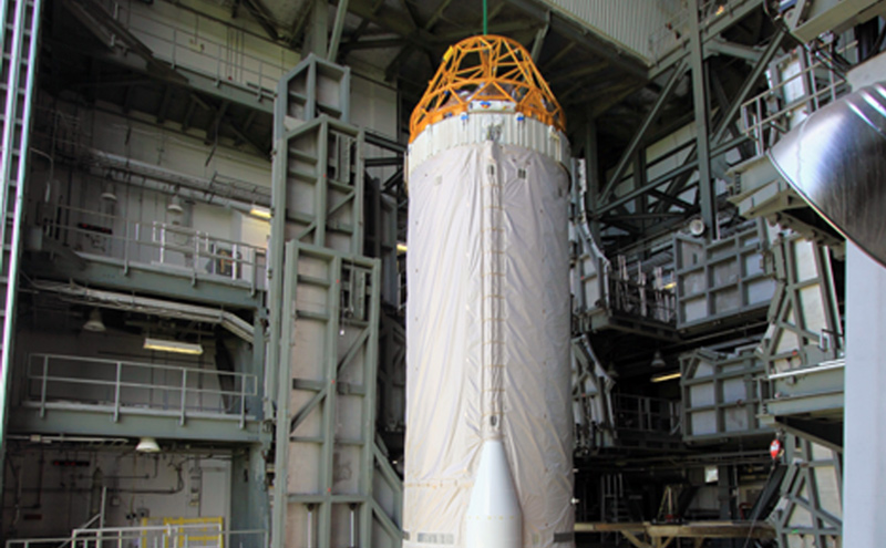 At Launch Complex 41 at Cape Canaveral Air Force Station in Florida, workers guide an overhead crane as it lifts the Centaur upper stage for the United Launch Alliance Atlas V in the Vertical Integration Facility (VIF).