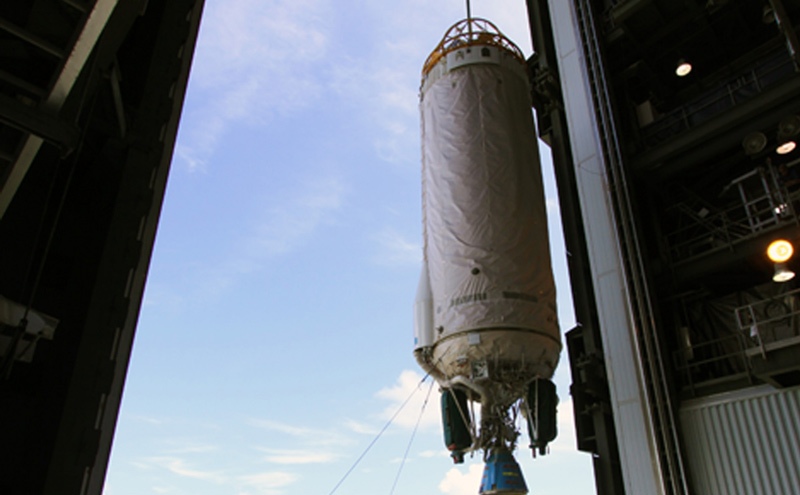 With a unique view taken from inside Vertical Integration Facility (VIF) at Launch Complex 41 at Cape Canaveral Air Force Station in Florida, an overhead crane lifts the Centaur upper stage for the United Launch Alliance Atlas V.