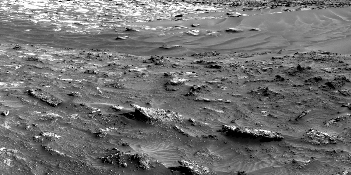 MSL mosaic showing sand and broken-up bedrock in the foreground, with numerous, large resistant features (our current focus) and the lighter-toned, apparently smoother bedrock in the background (possible sulfate-bearing).