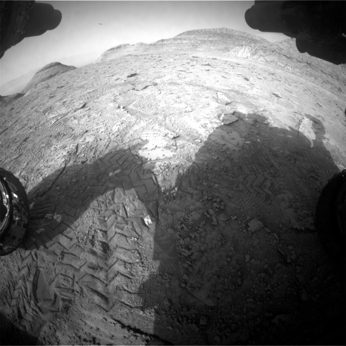 This image of the Curiosity rover's shadow over the Mars surface was taken by Front Hazard Avoidance Camera (Front Hazcam) onboard NASA's Mars rover Curiosity on Sol 3735. 