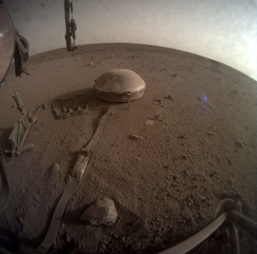 One of InSight's Last Images: This is one of the last images ever taken by NASA’s InSight Mars lander. Captured on Dec. 11, 2022, the 1,436th Martian day, or sol, of the mission, it shows InSight’s seismometer on the Red Planet’s surface. Credits: NASA/JPL-Caltech. Download image ›