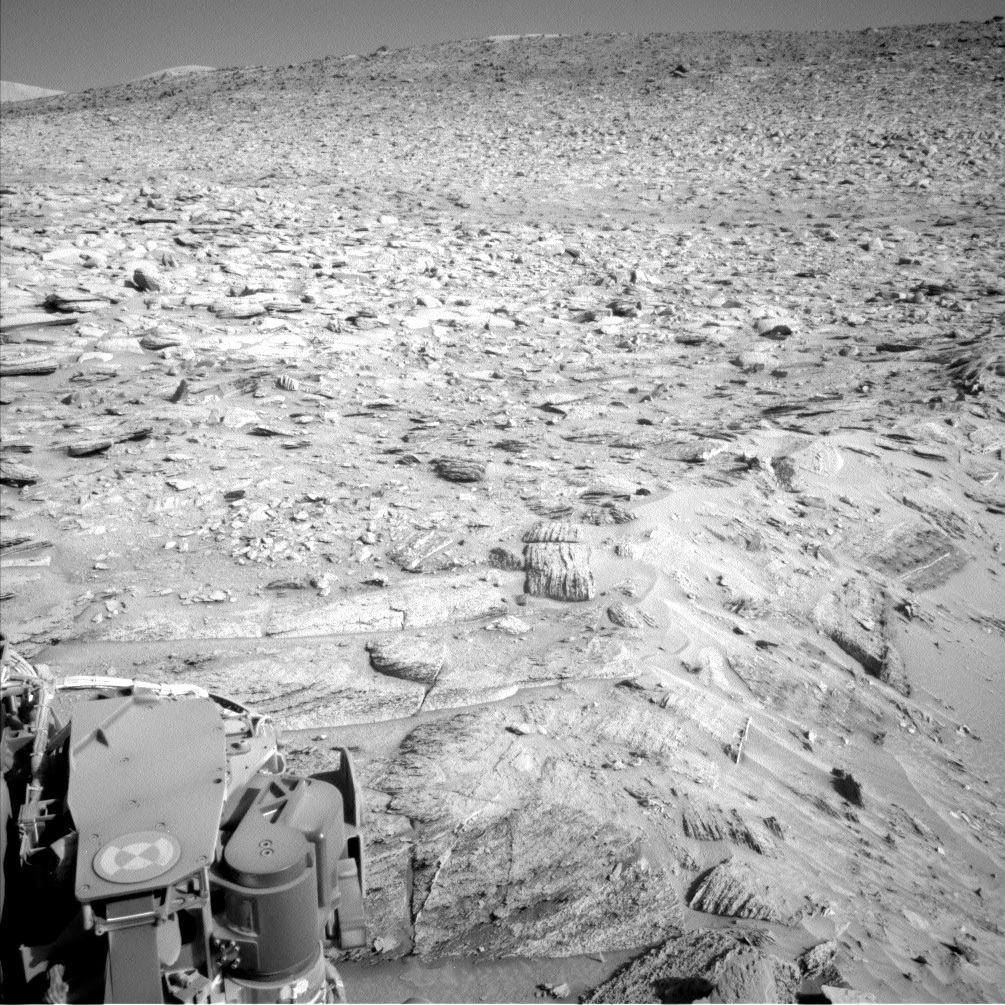 Navcam Image showing the rim of the second largest crater within the crater cluster (bottom right) and the Gediz Vallis ridge in the background (towards the top of the image).