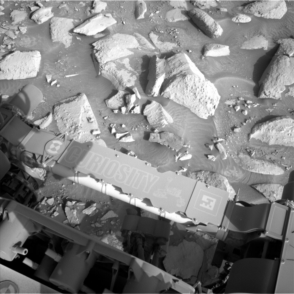 This image showing Curiosity's nameplate above the Mars surface was taken by the Left Navigation Camera onboard NASA's Mars Curiosity rover on Sol 3934.