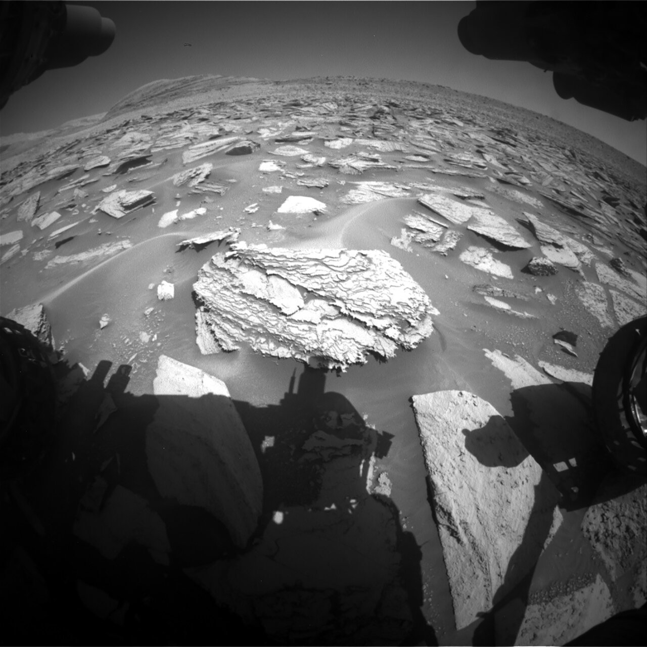 This image was taken by Front Hazard Avoidance Camera onboard NASA's Mars rover Curiosity on Sol 3969. It shows the shadow of the rover with the wheel making a slight appearance. 