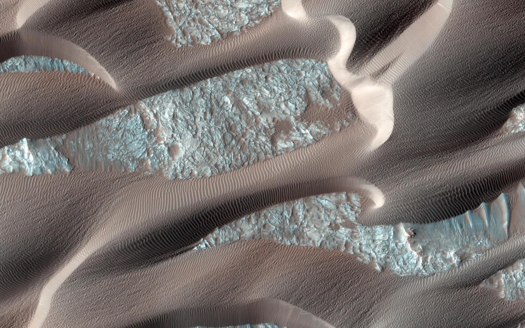 This image shows, smooth dark dunes, with lighter gray sand in between them.