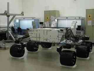 This image shows the body of the Mars Science Laboratory rover inside a clean room, supported by its six huge wheels and suspension system. Specially fitted platforms underneath the wheels hold the rover in place and prevent it from moving.