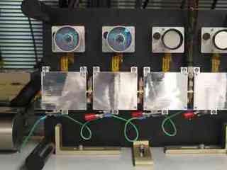 This image shows a closeup view of the two pairs of camera lenses on a shelf. The left-hand pair are larger than the right-hand pair, go to the hazard avoidance camera, and have a larger, fish-eye lens field of view for examining the rover's wheels and immediate surroundings. Its lenses are a clear, almost-turquoise blue. The right-hand pair of lenses are smaller and go to the navigation camera, which takes panoramic, far-field images of surrounding terrain.