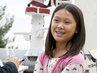 Clara Ma poses with a model of Curiosity.