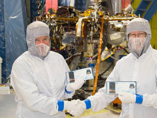 InSight project manager Tom Hoffman and principal investigator Bruce Banerdt pose with their "boarding passes" in 2015, showing that they're both sending their names to Mars.	