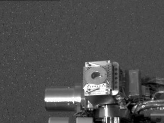This image taken at Meridiani Planum, Mars, by the panoramic camera on the Mars Exploration Rover Opportunity shows the rover's Moessbauer spectrometer (circular device in center), located on its instrument deployment device, or "arm." The image was acquired on the ninth martian day or sol of the rover's mission.