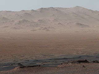A viewpoint on "Vera Rubin Ridge" provided NASA's Curiosity Mars rover this detailed look back over the area where it began its mission inside Gale Crater, plus more-distant features of the crater. The right-eye, telephoto-lens camera of the rover's Mastcam took the component images Oct. 25, 2017.