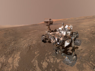 rover on mars surface with mountain in background 