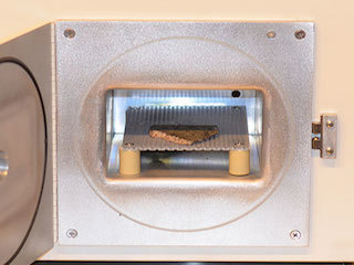 rock visible in open door of machine