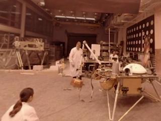 engineers in lab with spacecraft