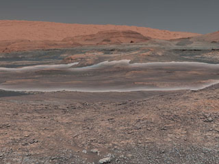 This mosaic taken by NASA's Mars Curiosity rover looks uphill at Mount Sharp, which Curiosity has been climbing. 