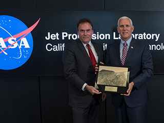 U.S. Vice President Mike Pence, right, is presented a plaque by JPL Director Michael Watkins during a tour of NASA's Jet Propulsion Laboratory, Saturday, April 28, 2018 in Pasadena, California. The plaque presents a view of the Mars Science Laboratory rover Curiosity on the surface of Mars.