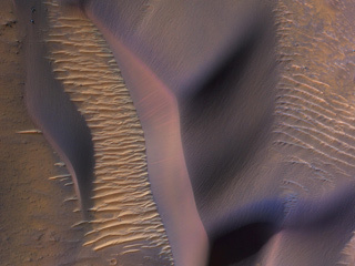 This image from NASA's Mars Reconnaissance Orbiter shows sand dunes on the slopes of Nectaris Montes within Coprates Chasma.