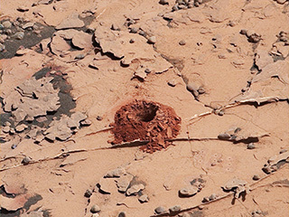 A close-up image of a 2-inch-deep hole produced using a new drilling technique for NASA's Curiosity rover. The hole is about 0.6 inches across (1.6 centimeters). This image was taken by Curiosity's Mast Camera (Mastcam) on Sol 2057. It has been white balanced and contrast enhanced.