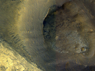 This image from NASA's Mars Reconnaissance Orbiter shows a hill with a central crater on the floor of Valles Marineris. It could be either a real volcano, the kind that erupts lava, or a sedimentary structure called a mud volcano.