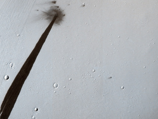 This image from NASA's Mars Reconnaissance Orbiter shows an impact crater that triggered a slope streak. When a meteoroid hit the surface and exploded to make the crater, it destabilized the slope and initiated this avalanche.