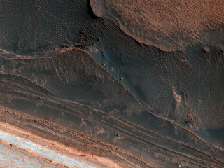 Ice block avalanche. This image from NASA's Mars Reconnaissance Orbiter shows many new ice blocks compared to earlier images in 2006.