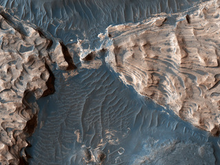 This image from NASA's Mars Reconnaissance Orbiter shows Aram Chaos, a 280-kilometer-wide impact crater in the Southern Highlands. Uplifted blocks of hematite and water-altered silicates indicate that this crater once held a lake.