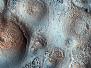 This image shows relatively bright mounds, hundreds of meters in size, scattered throughout darker and diverse surfaces in Chryse Planitia. The largest shows a central pit, similar to the collapsed craters in some Earth volcanoes. 