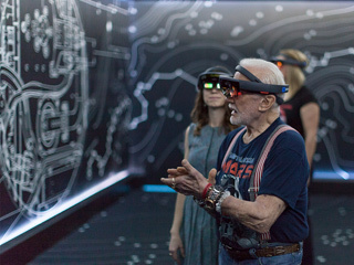 Apollo 11 astronaut Buzz Aldrin and Erisa Hines of NASA's Jet Propulsion Laboratory in Pasadena, California, try out the Microsoft HoloLens mixed-reality headset during a preview of "Destination: Mars" at Kennedy Space Center visitor complex in Florida.