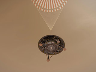 This illustration shows a simulated view of NASA's InSight lander descending towards the surface of Mars on its parachute.