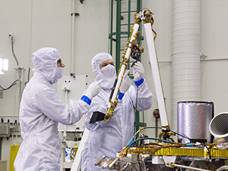 Engineers at Lockheed Martin Space, Denver, Colorado, test the robotic arm on NASA's InSight lander several months before launch.
