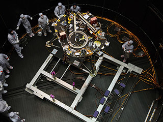 Engineers at Lockheed Martin Space, Denver, Colorado, prepare NASA's InSight lander for testing in a thermal vacuum chamber several months before launch.