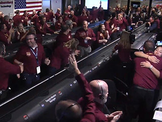 The NASA InSight team reacts after receiving confirmation that the spacecraft successfully touched down on the surface of Mars, inside the Mission Support Area at NASA's Jet Propulsion Laboratory in Pasadena, California.
