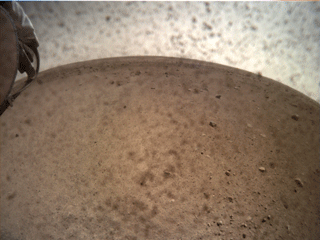 NASA’s InSight spacecraft popped the lens cover off its Instrument Context Camera (ICC) on Nov. 30, 2018, and captured this view of Mars. 