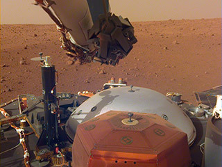 This image from InSight's robotic-arm mounted Instrument Deployment Camera shows the instruments on the spacecraft's deck, with the Martian surface of Elysium Planitia in the background. The image was received on Dec. 4, 2018 (Sol 8).
