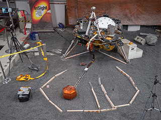 ForeSight, a fully functional, full-size model of NASA's InSight lander, sits in a lab space that has been sculpted to match terrain in front of the real lander on Mars. This work was done at NASA's Jet Propulsion Laboratory in Pasadena, California.
