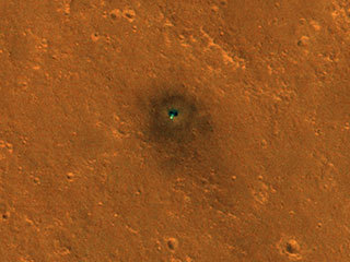 NASA's InSight spacecraft and its recently deployed Wind and Thermal Shield were imaged on Feb. 4 by the HiRISE camera aboard NASA's Mars Reconnaissance Orbiter.