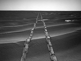 In this navigation camera raw image, NASA's Opportunity Rover looks back over its own tracks on Aug. 4, 2010. NASA's Jet Propulsion Laboratory, a division of Caltech in Pasadena, manages the Mars Exploration Rover Project for NASA's Science Mission Directorate, Washington.