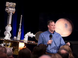 NASA Administrator Jim Bridenstine discusses the successful completion of the Opportunity Mars rover mission during a news briefing at the agency's Jet Propulsion Laboratory in Pasadena, California. Behind him to the left is a model of Opportunity and to the right behind him is an image of Mars.