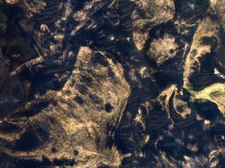 This image acquired on January 20, 2019 by NASAs Mars Reconnaissance Orbiter, shows a chaotic jumble of bright layered sediments, perhaps resulting from large landslides.