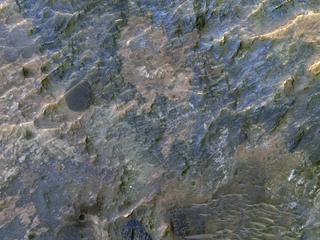 This image acquired on January 23, 2019 by NASAs Mars Reconnaissance Orbiter, shows the western portion of a well-preserved (recent) impact crater in Ladon Basin.