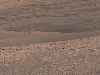 The hills and troughs in this little valley, carved between a ridge and cliffs higher up Mount Sharp, almost look like undulating waves. 