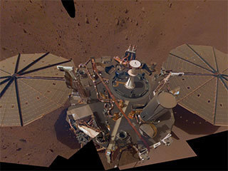 This is NASA InSight's second full selfie on Mars. Since taking its first selfie, the lander has removed its heat probe and seismometer from its deck, placing them on the Martian surface; a thin coating of dust now covers the spacecraft as well.