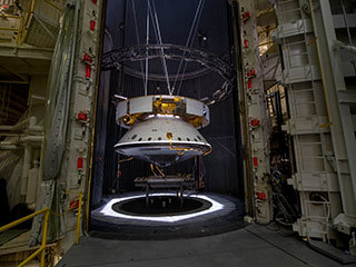 The completed spacecraft that will carry the Mars 2020 rover to the Red Planet, next year hangs suspended by cables inside the Space Simulator Facility at NASA's Jet Propulsion Laboratory in Pasadena, California. The image was taken on May 9, 2019.