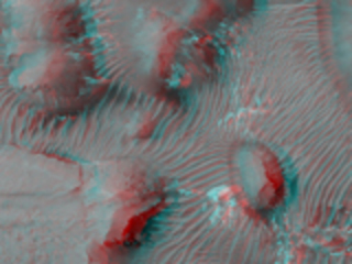 A variety of landforms, including isolated hills, eroded mesas, dark eroded sediments, and dunes are seen within an area called "Aram Chaos." 