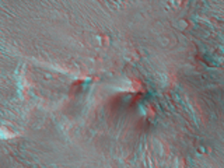 An image of the transitional terrain where the linear troughs and rounded pits of an area called "Noctis Labyrinthus" merge with the larger canyon of "Valles Marineris."