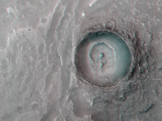 This image show a fan-shaped deposit where a channel enters a crater. 