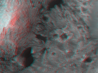 This image shows layered blocks tilted at high angles, diverse color and textures and dark dunes.