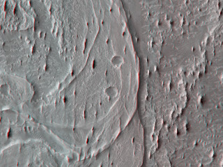 The smaller, narrow ridges oriented vertically are yardangs