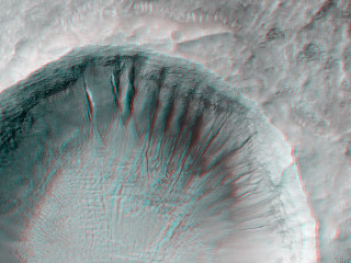 This impact crater has gullies incised into its walls on the north and eastern sides.
