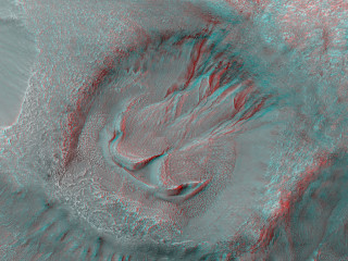 This crater has gullies on its southwest-facing walls and rim, as well as and what appears to be two separate instances of lobate (ear-shaped) material associated to its interior gullies.
